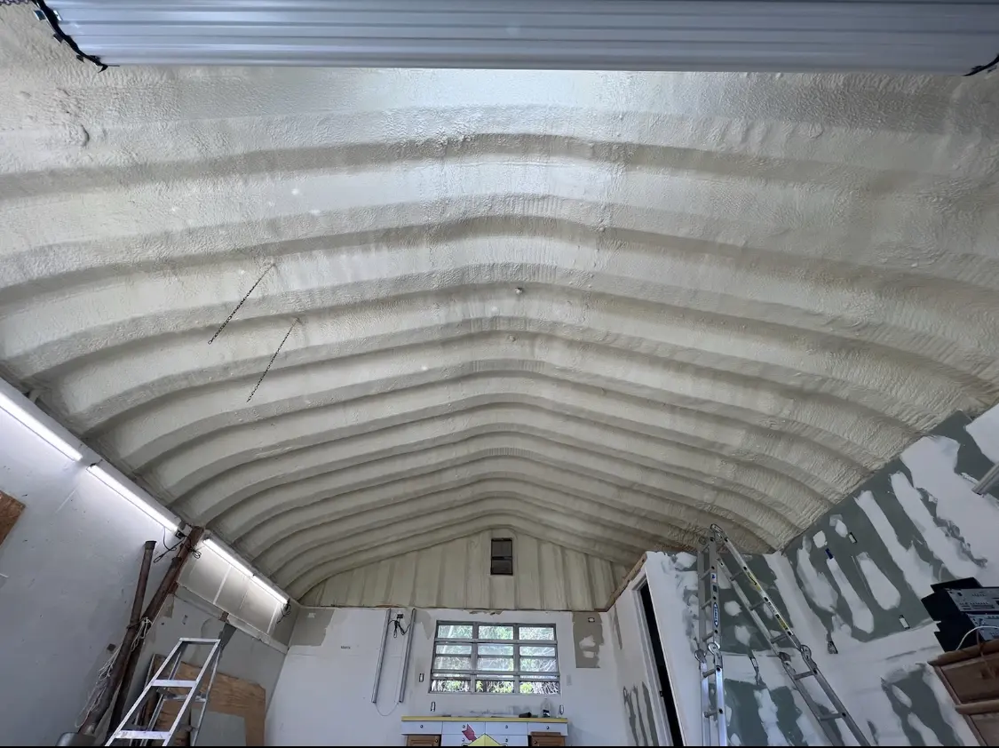 Spray polyurethane foam applied to the underside of a metal roof deck in Mays Chapel